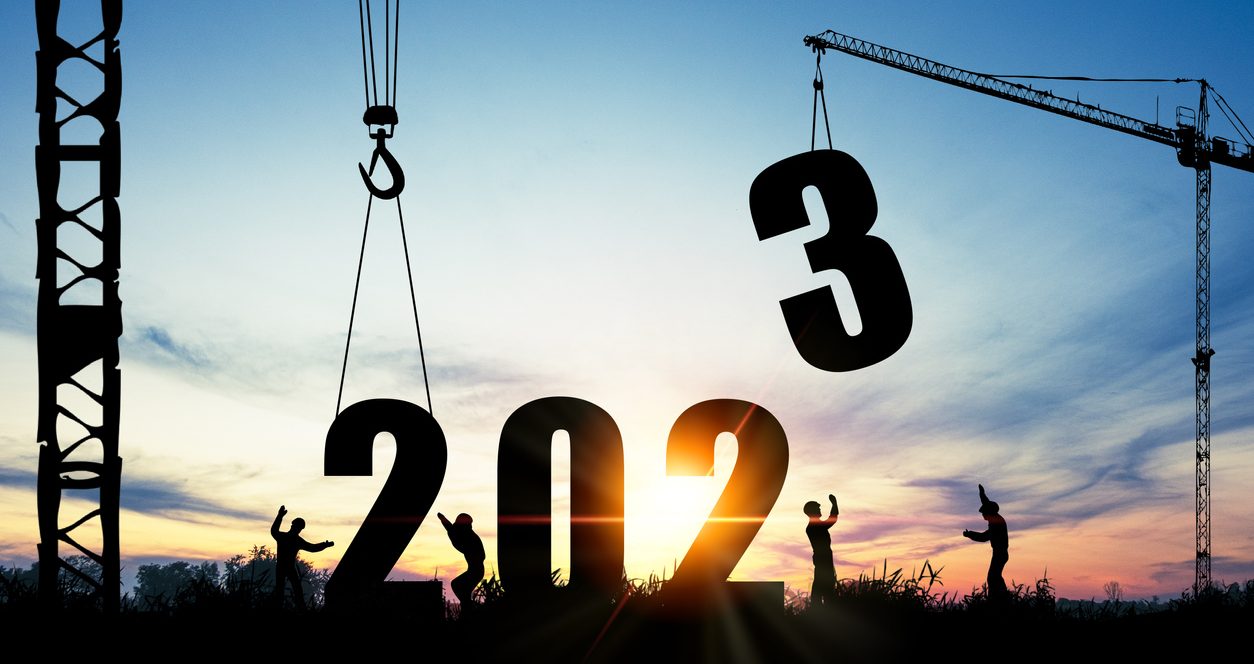 Silhouette of construction worker with crane and sunrise for preparation of welcome 2023