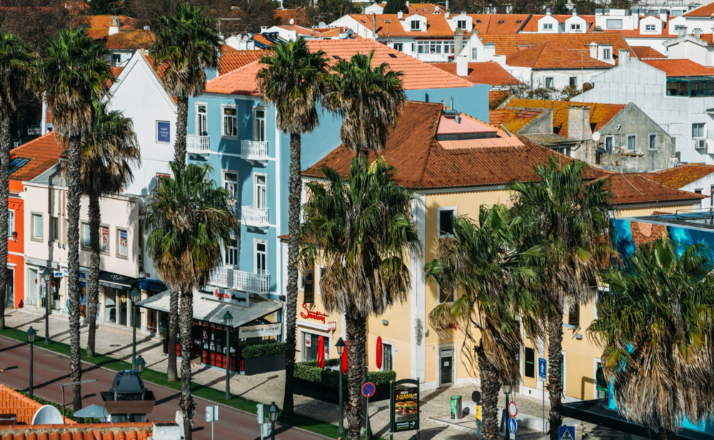 High perspective view of people and colourful buildings along Cascais, Portugal's Alameda Combatentes da Grande Guerra avenue