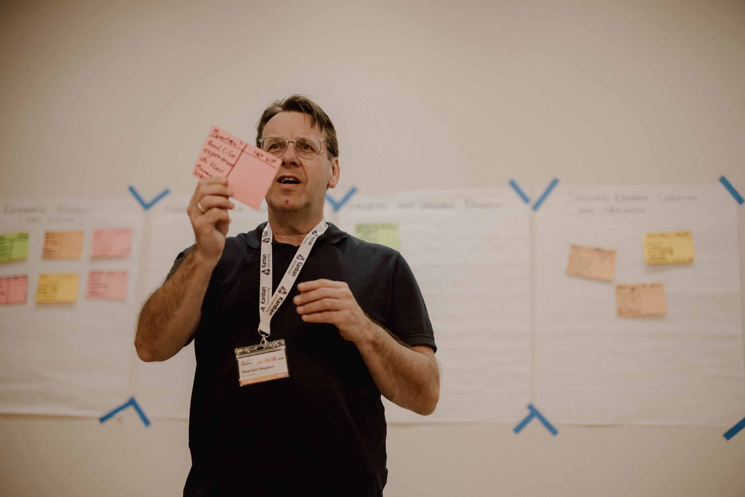 A Lead Different Retreat participant presenting ideas beside a wall of notes
